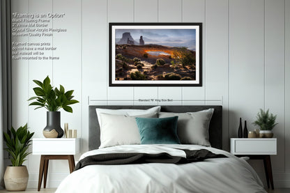 a bedroom with a large bed and a painting on the wall