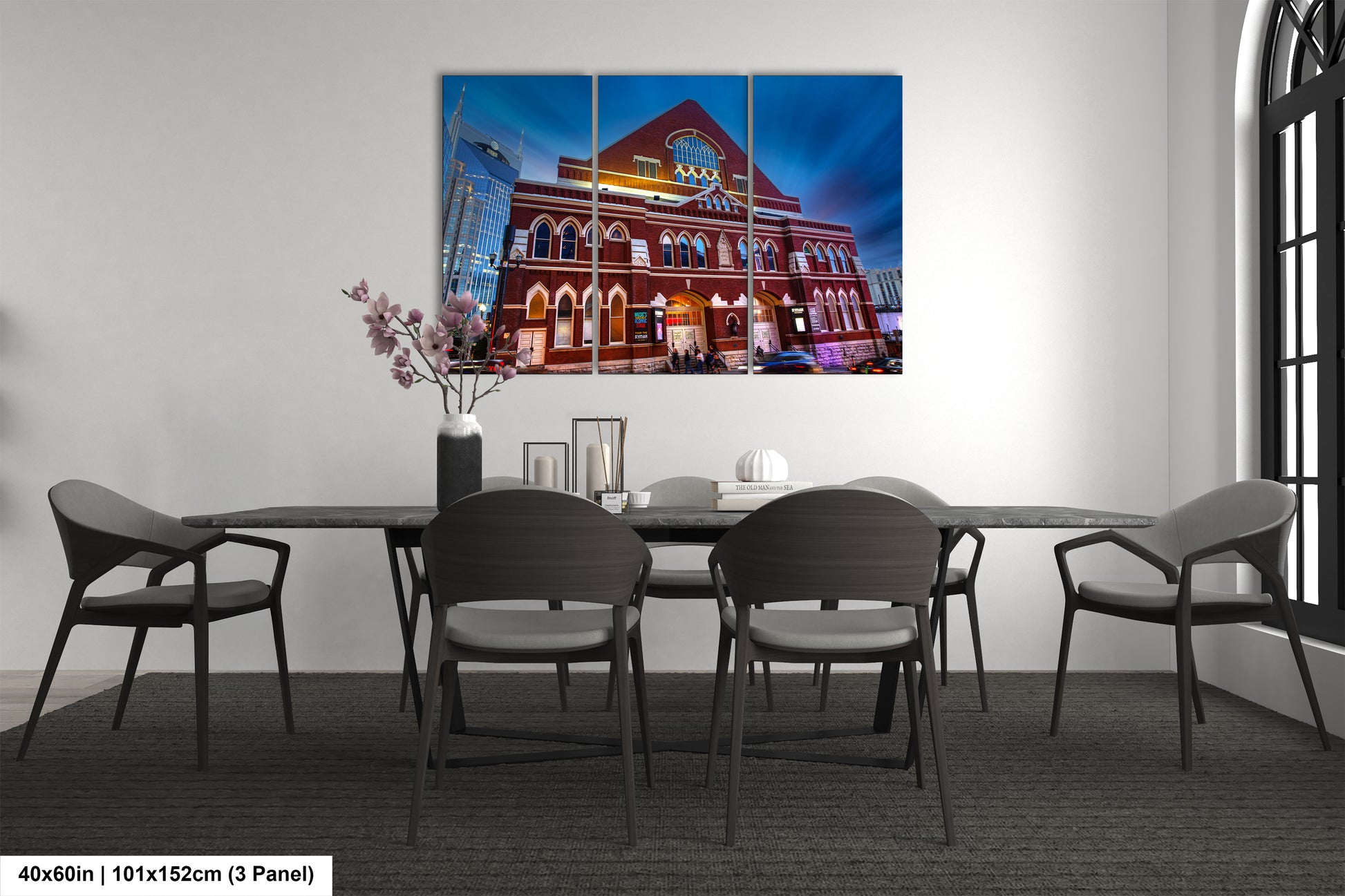 a room with a table and chairs and a painting on the wall