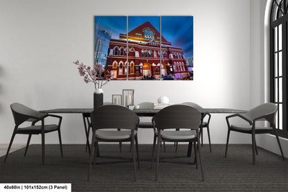 a room with a table and chairs and a painting on the wall