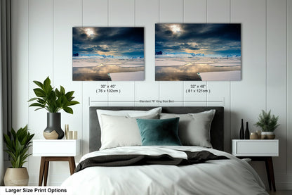 a bedroom with a bed and two pictures on the wall
