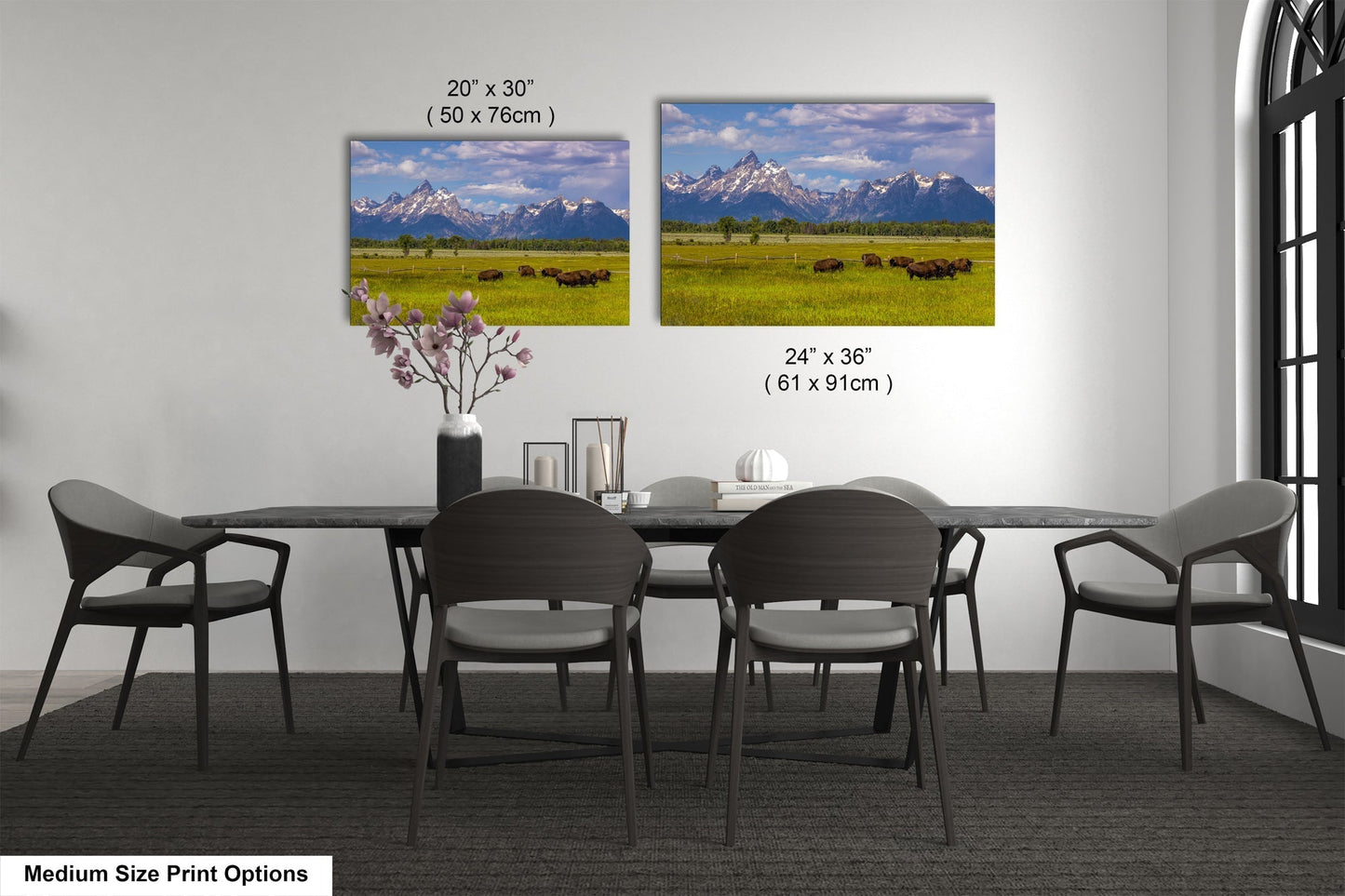 a dining room table with four chairs and a vase of flowers