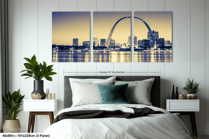 a bedroom with a large bed and a picture of the st louis skyline
