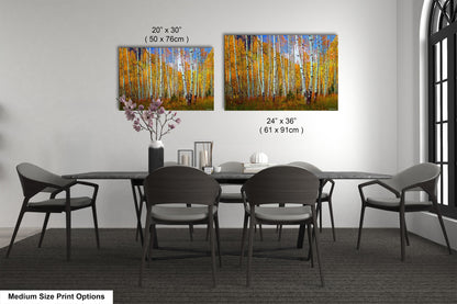 a dining room table with four chairs and a painting on the wall