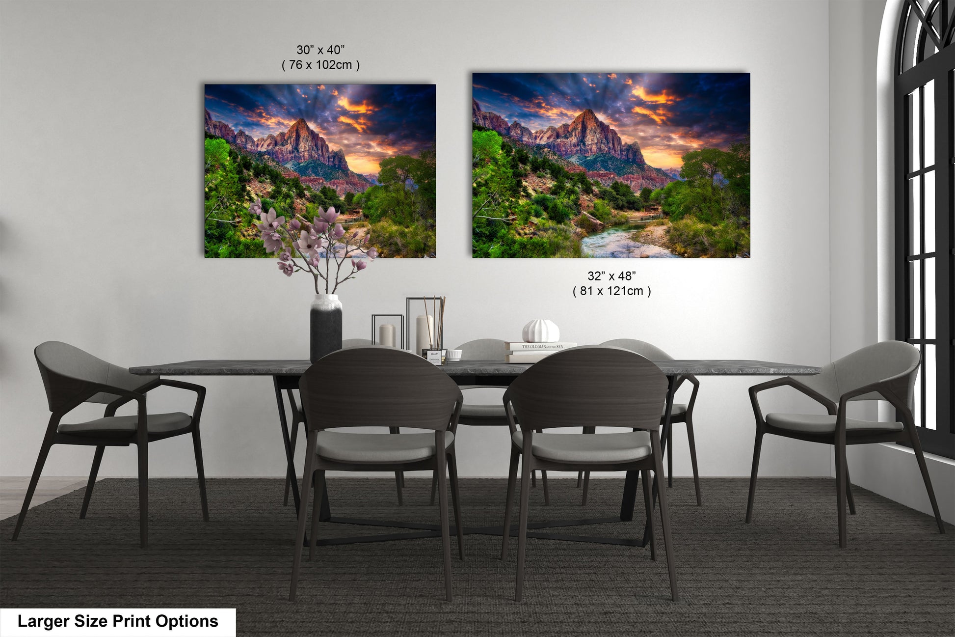 a dining room table with four chairs and two pictures on the wall