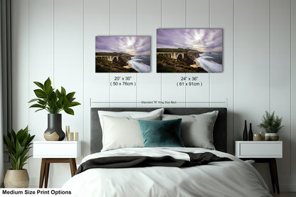 a bedroom with a bed and two pictures on the wall