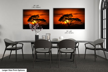 a dining room table with four chairs and a vase of flowers