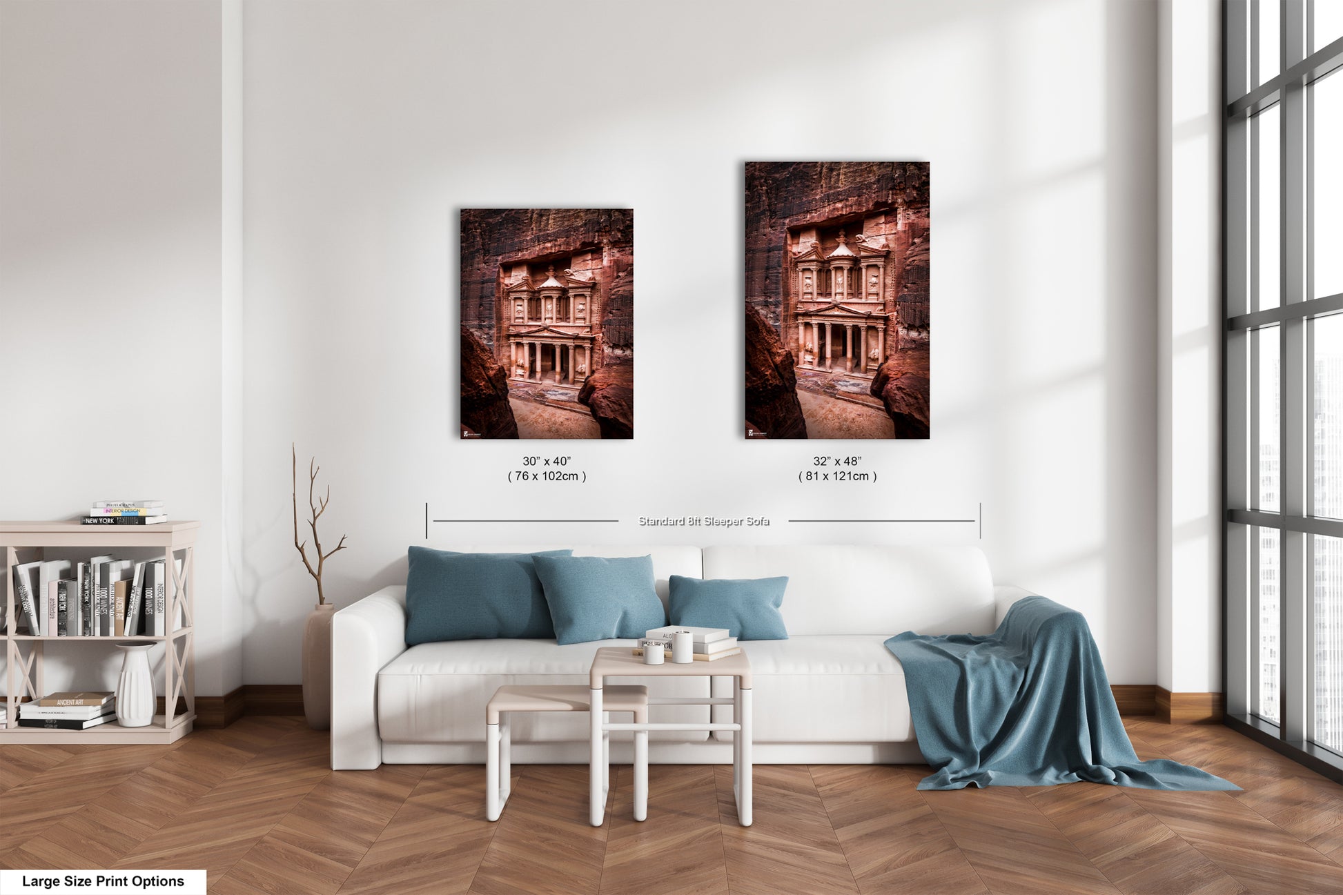 a living room with a white couch and two pictures on the wall