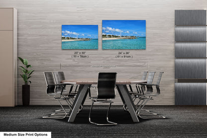 a dining room table with chairs and two pictures on the wall