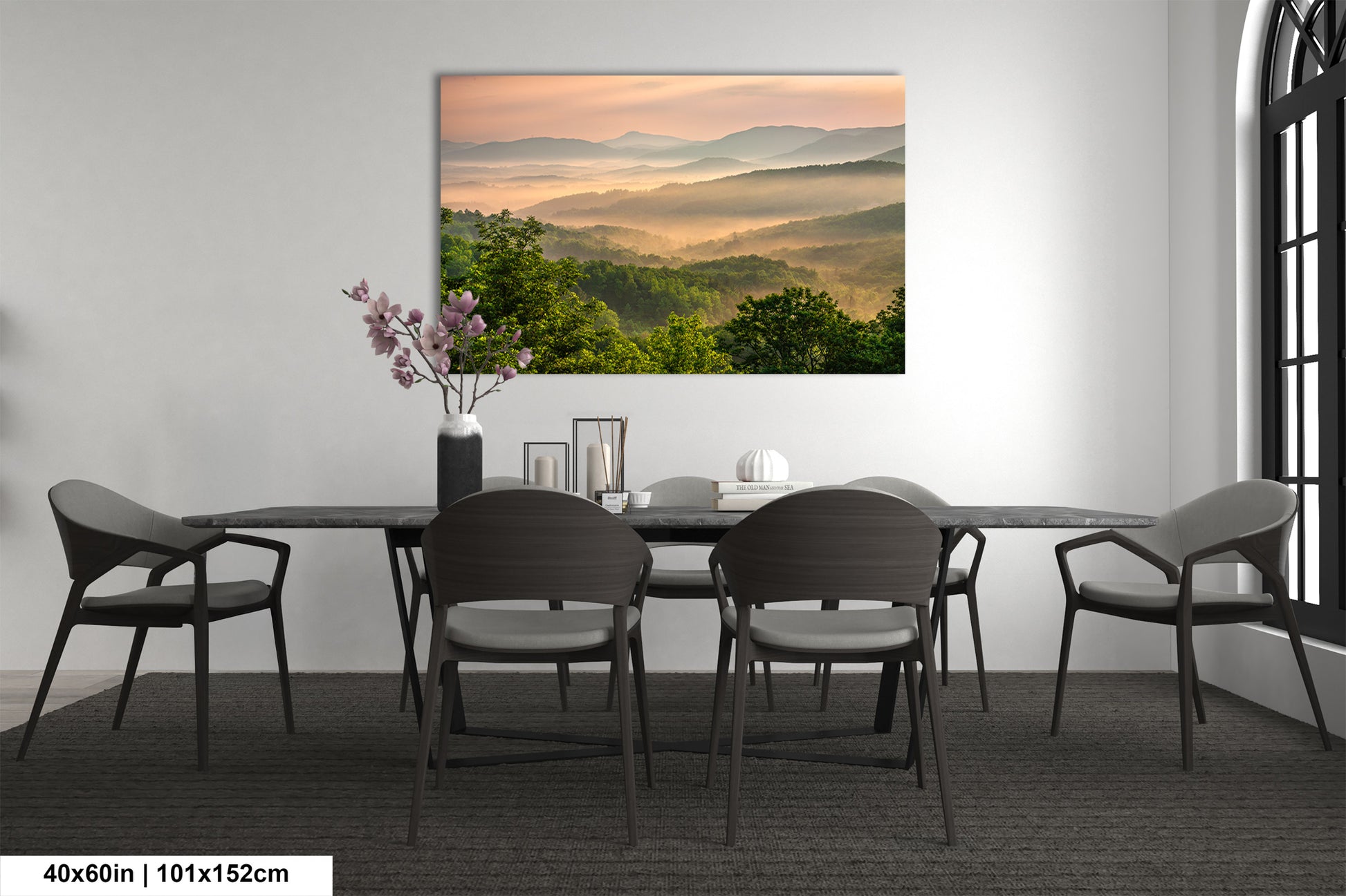 a dining room table with chairs and a painting on the wall