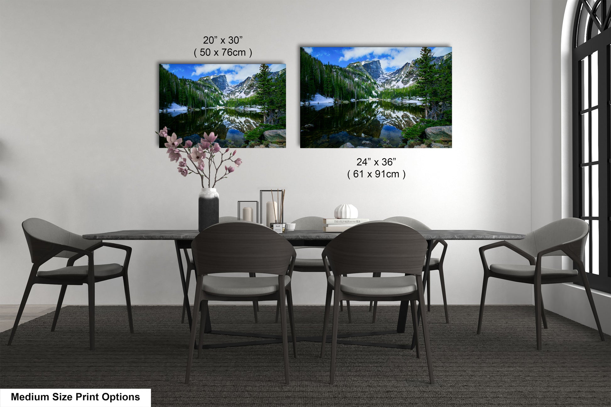 a dining table with four chairs and a vase of flowers