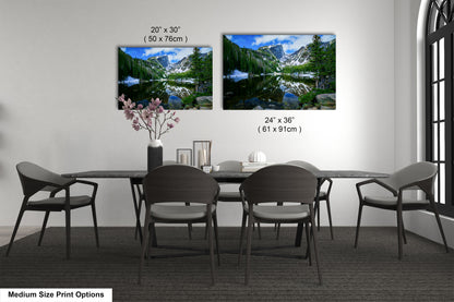 a dining table with four chairs and a vase of flowers