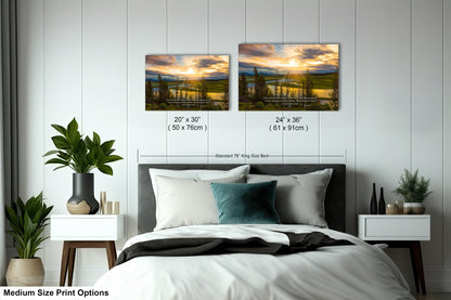 a bed room with a neatly made bed and two pictures on the wall