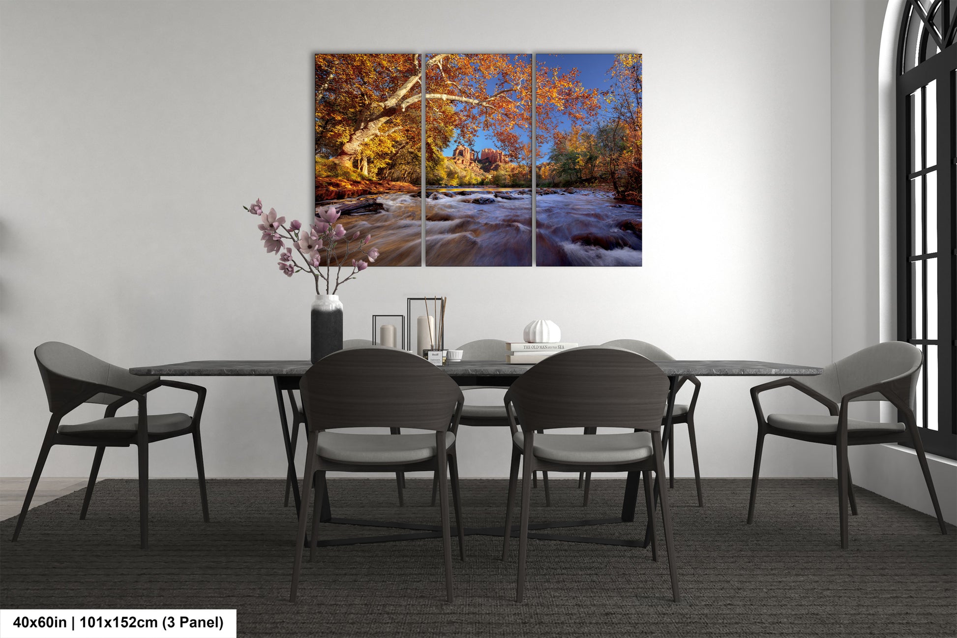 a dining room table with chairs and a painting on the wall