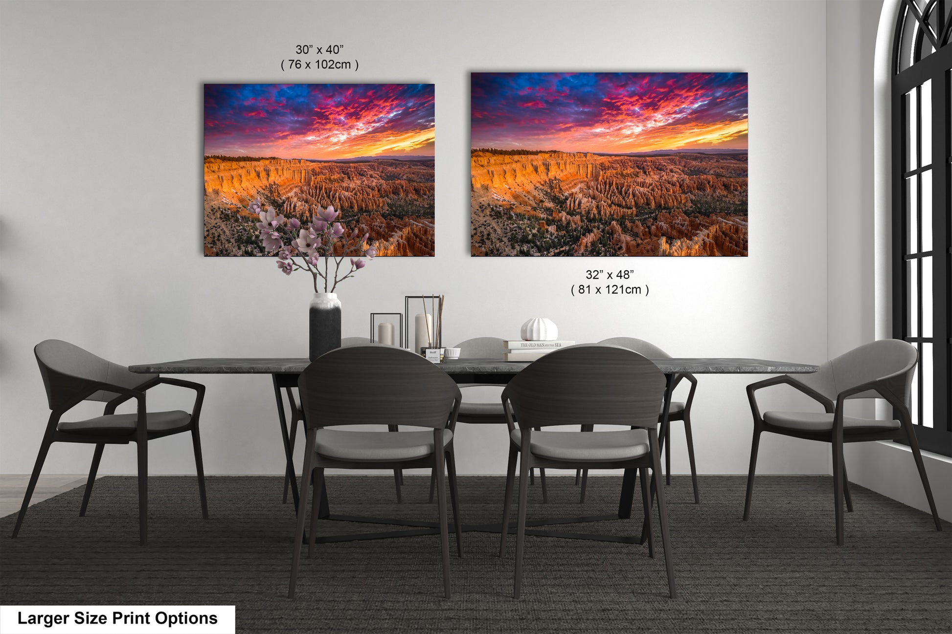 a dining room table with four chairs and a painting on the wall