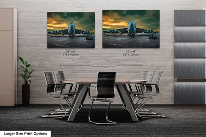 a dining room table with chairs and two pictures on the wall