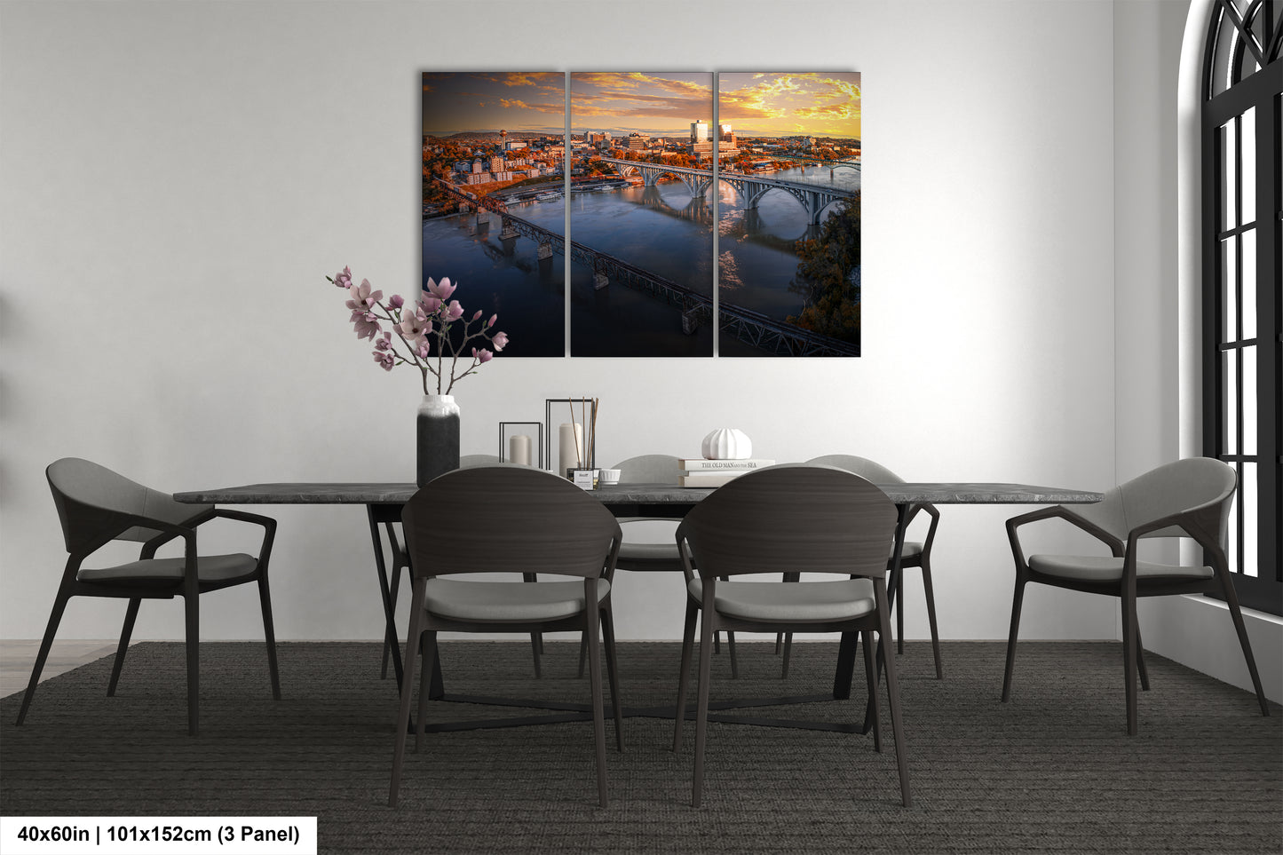 a dining room table with chairs and a painting on the wall