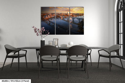 a dining room table with chairs and a painting on the wall