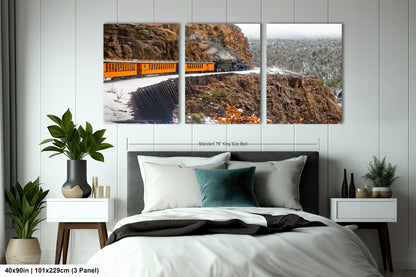 a bed room with a neatly made bed and two pictures on the wall