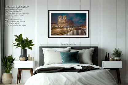 a bedroom with a large bed and a picture hanging on the wall
