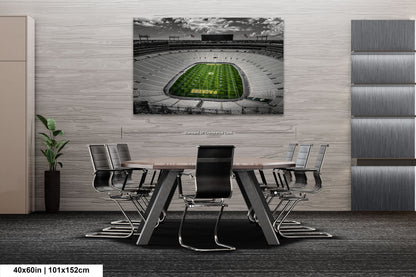 a table with chairs and a painting of a football stadium