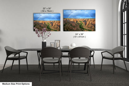 a dining table with four chairs and a vase with flowers