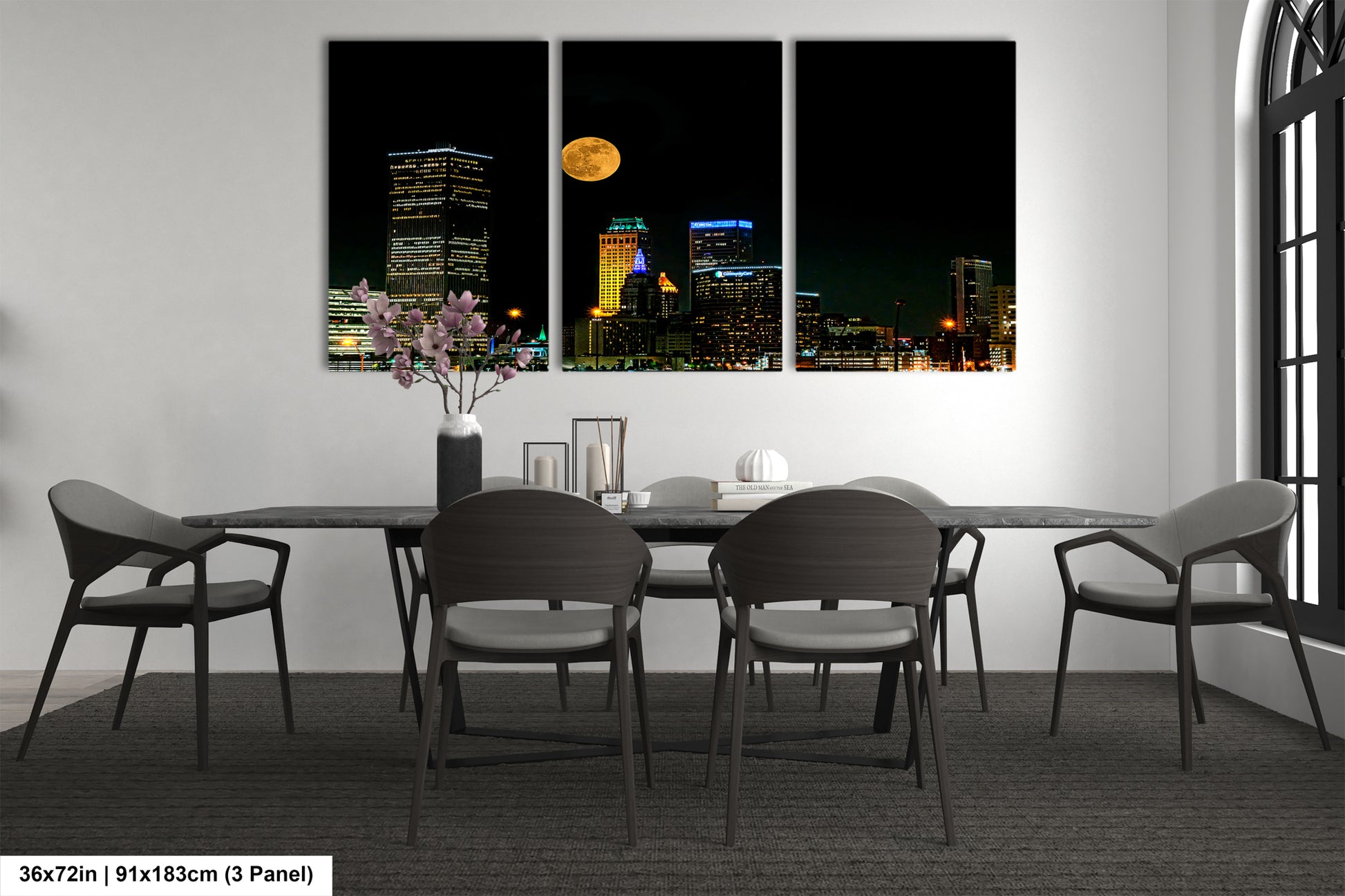 a dining room table with four chairs and a vase of flowers