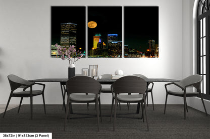 a dining room table with four chairs and a vase of flowers