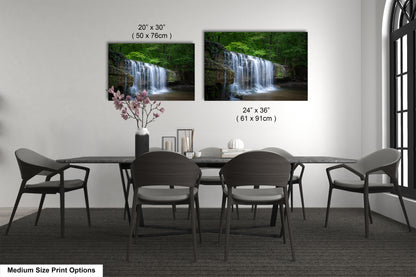 a dining room table with four chairs and a vase of flowers
