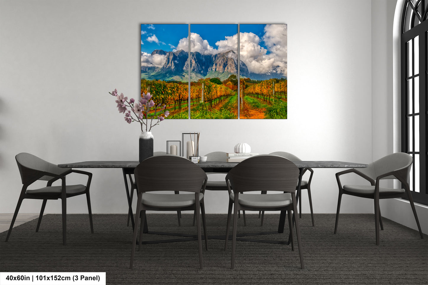 a dining room table with four chairs and a painting on the wall