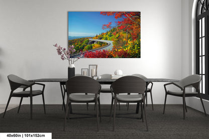 a dining room table with chairs and a painting on the wall
