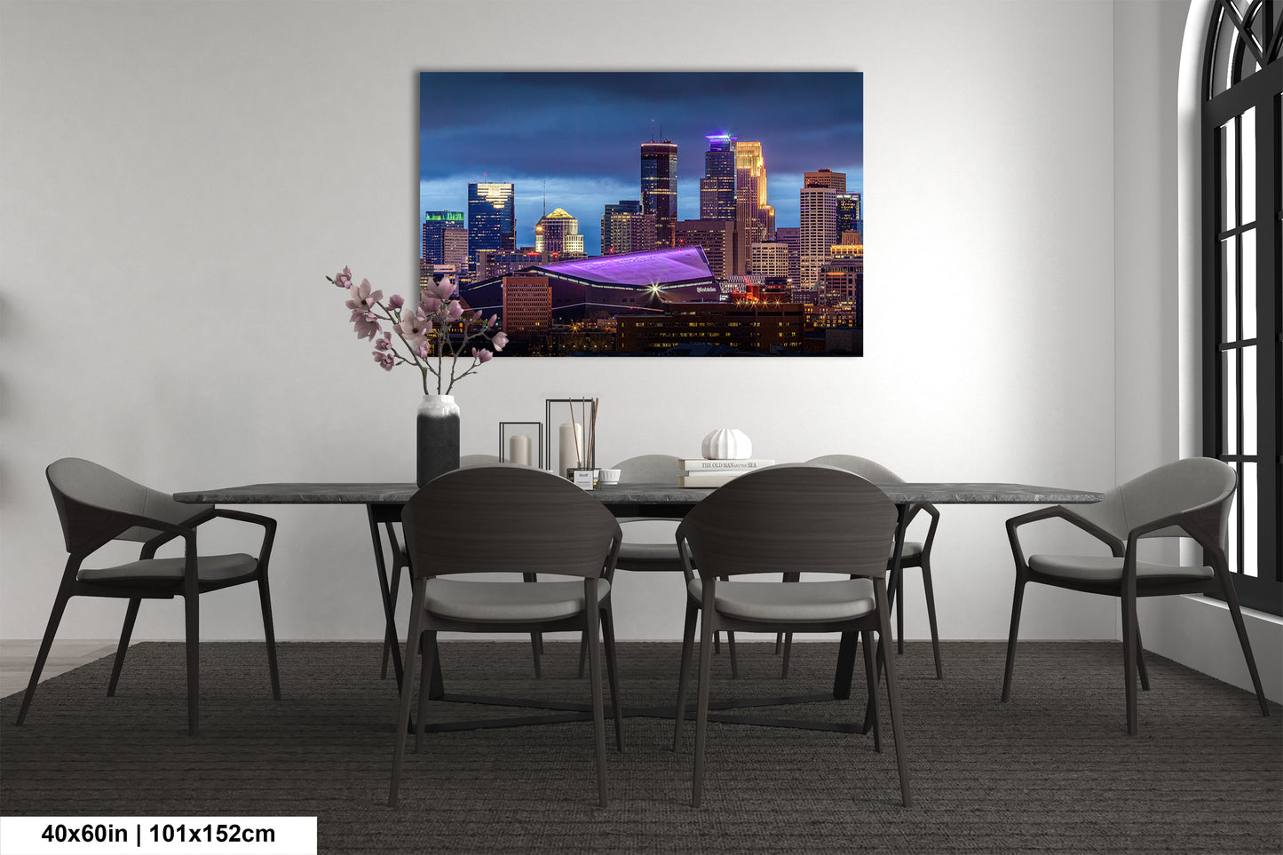 a room with a table and chairs and a painting on the wall
