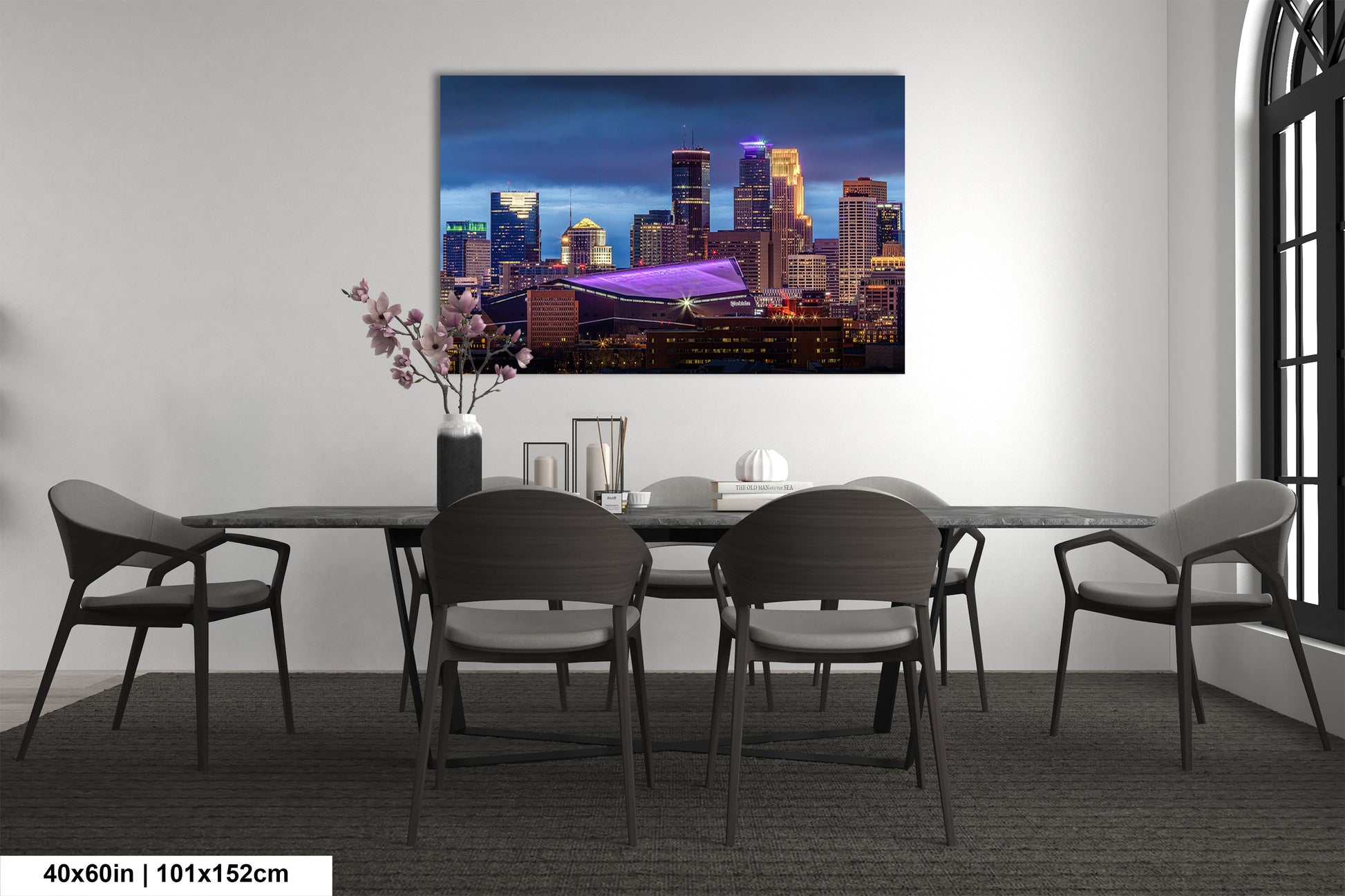 a room with a table and chairs and a painting on the wall
