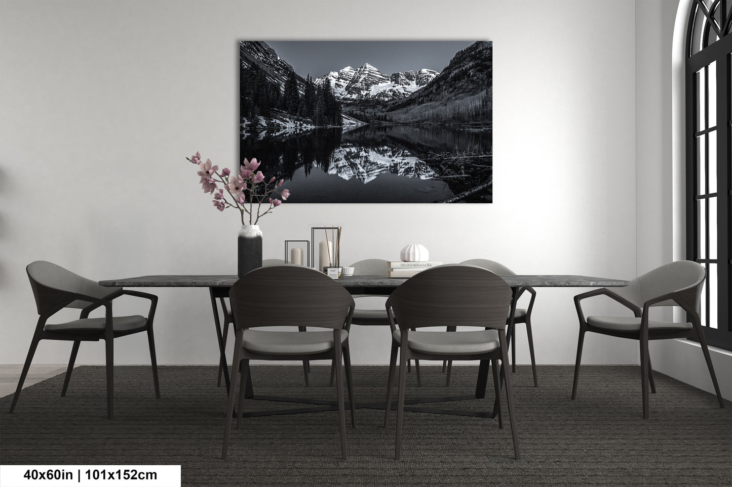 a black and white photo of a dining room table