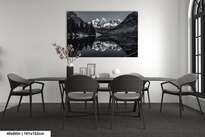 a black and white photo of a dining room table