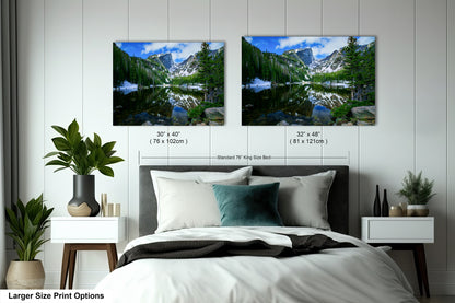 a bedroom with a bed and two pictures on the wall