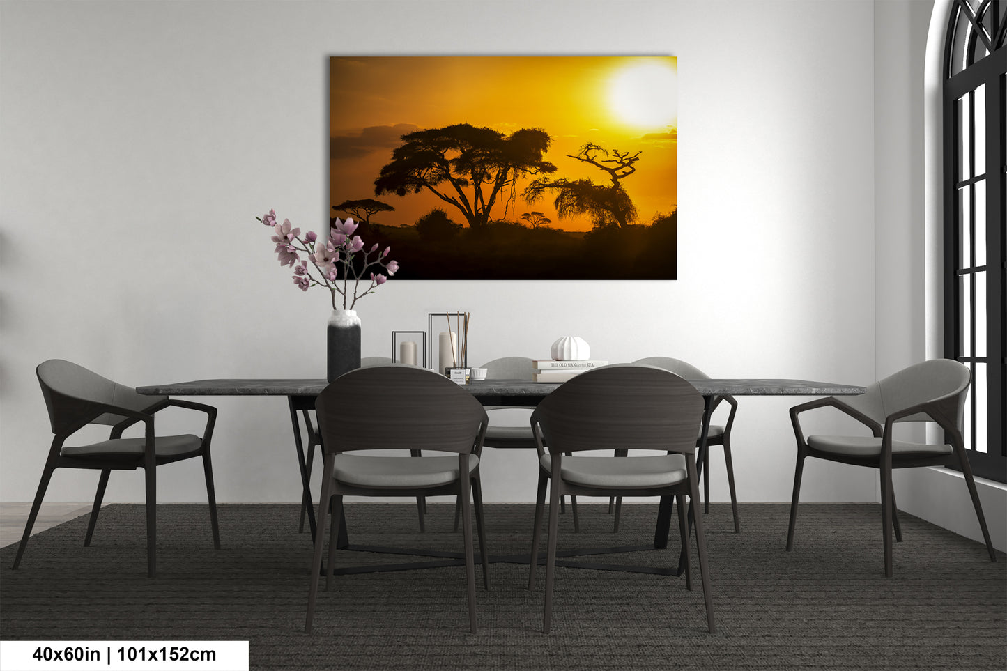 a dining room table with chairs and a painting on the wall