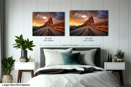 a bedroom with a bed and two pictures on the wall