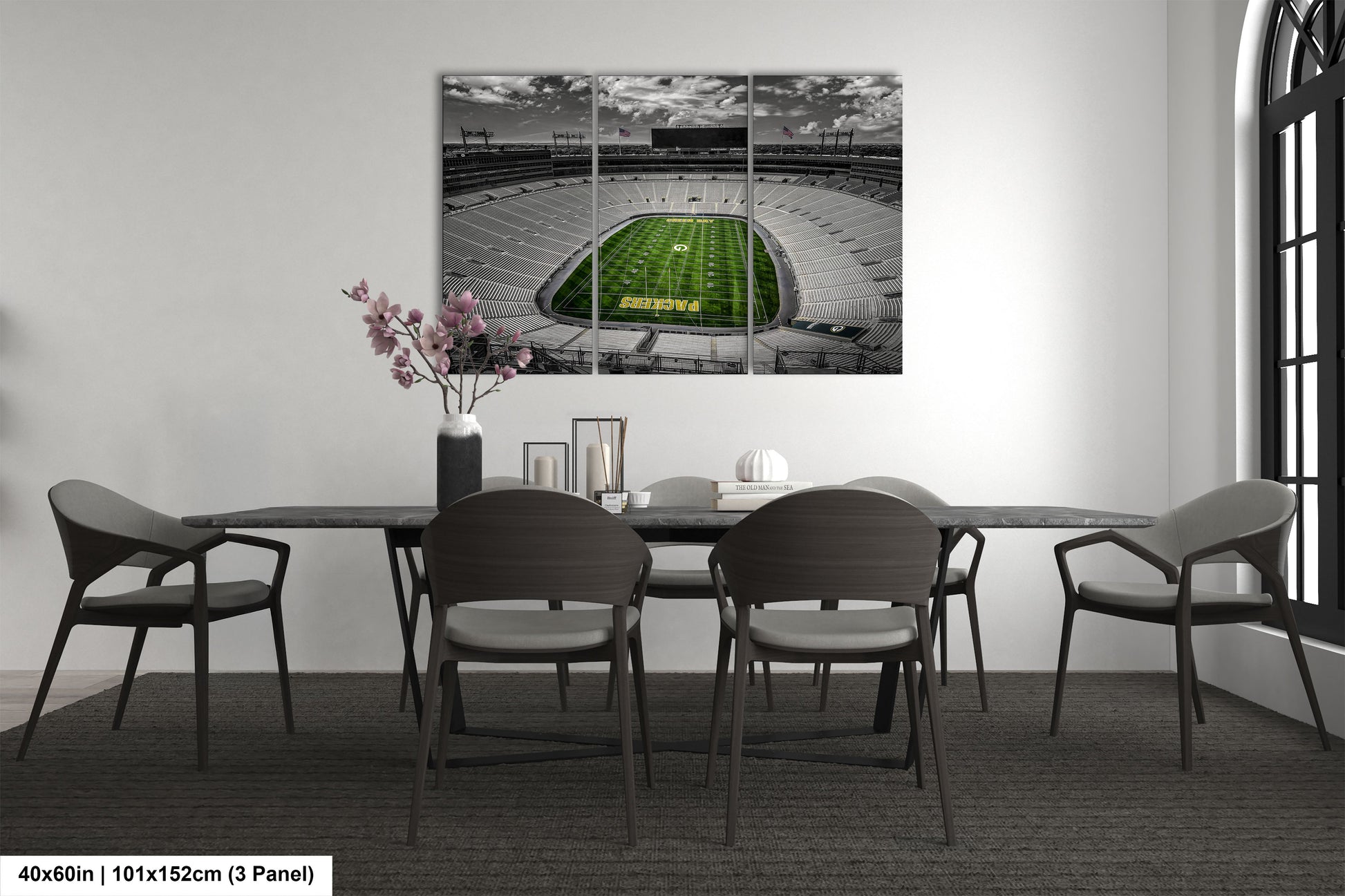 a dining room table with chairs and a painting of a football field
