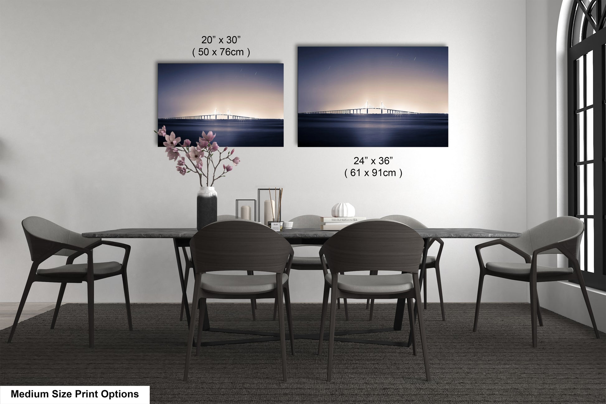 a dining table with four chairs and a vase of flowers