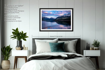 a bedroom with a bed and a picture hanging on the wall