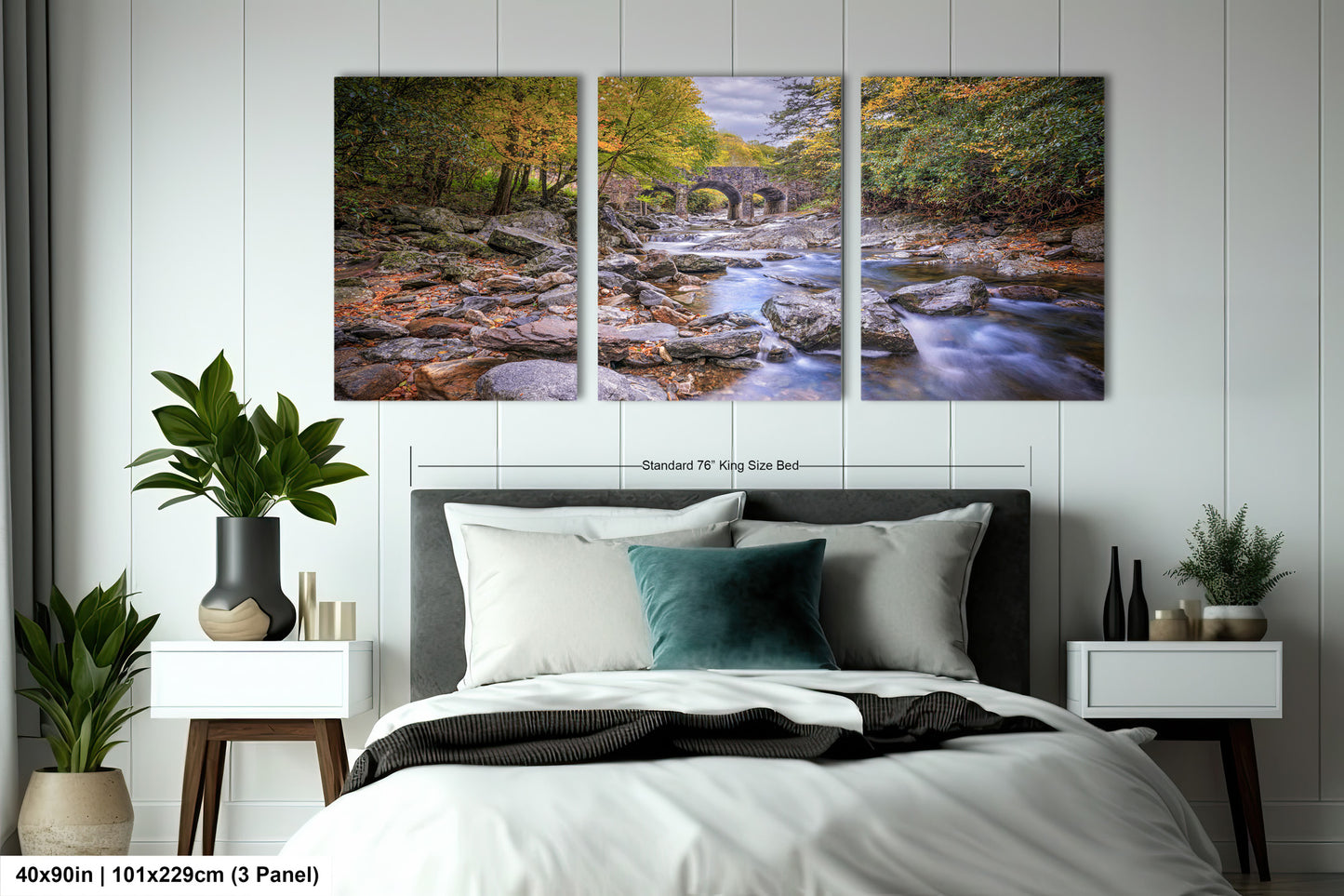 a bed room with a neatly made bed and two paintings on the wall