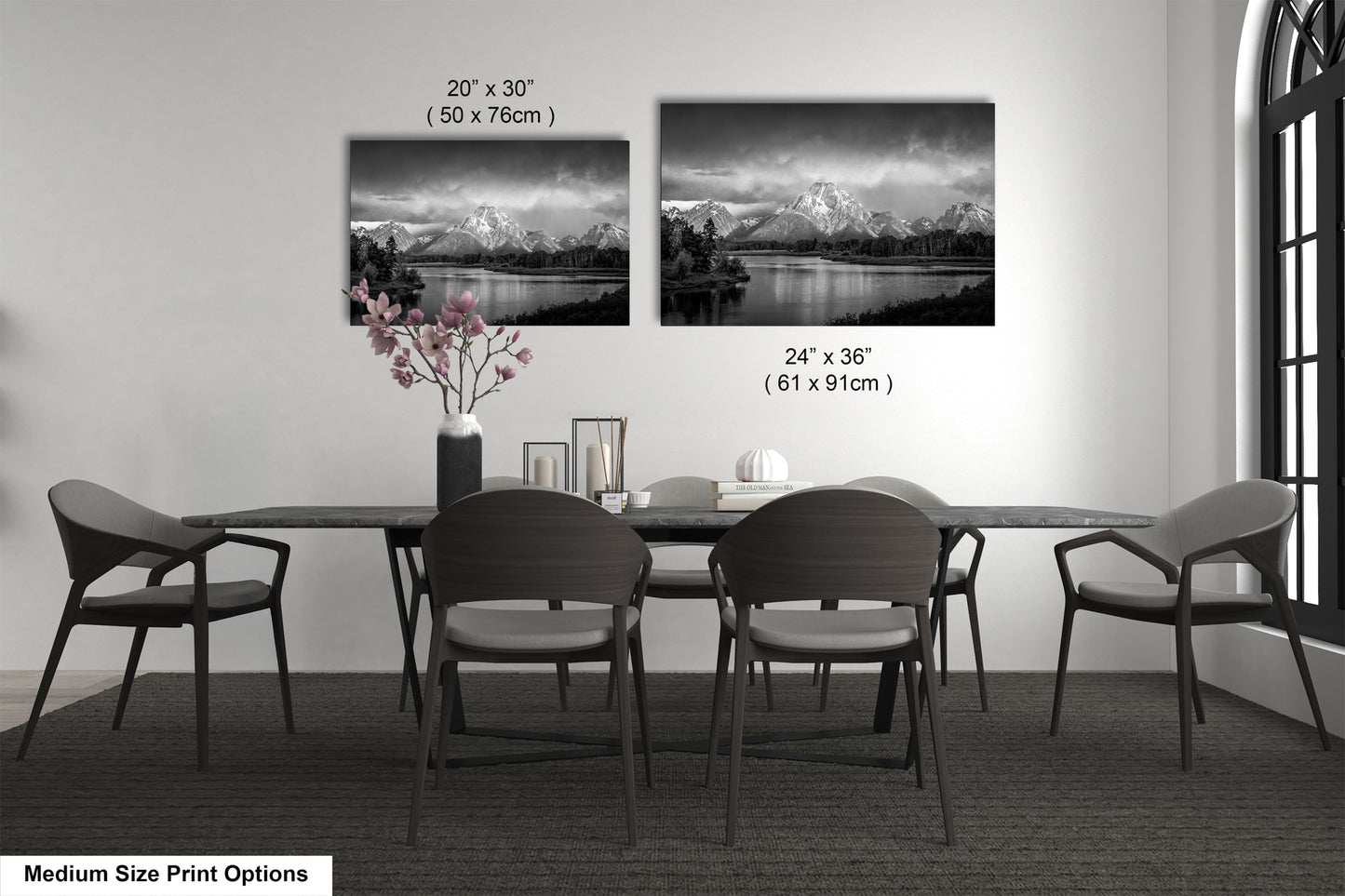 a dining table with four chairs and a vase of flowers