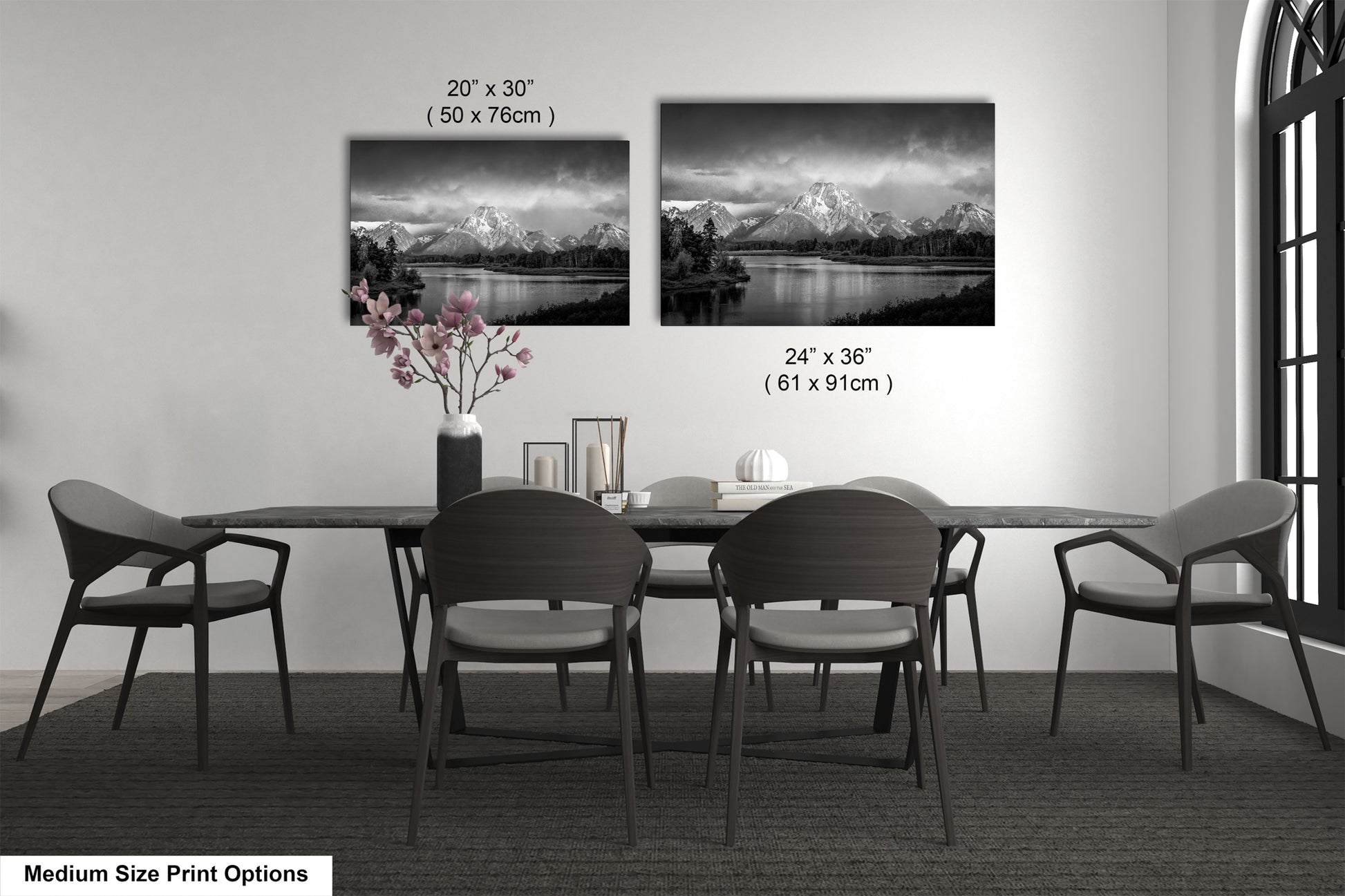 a dining table with four chairs and a vase of flowers
