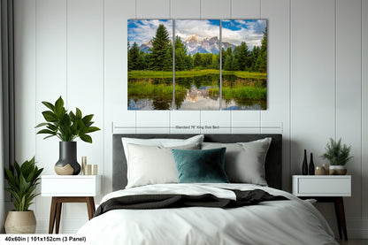 a bed room with a neatly made bed and a painting on the wall