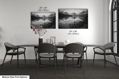 a dining table with four chairs and a vase of flowers