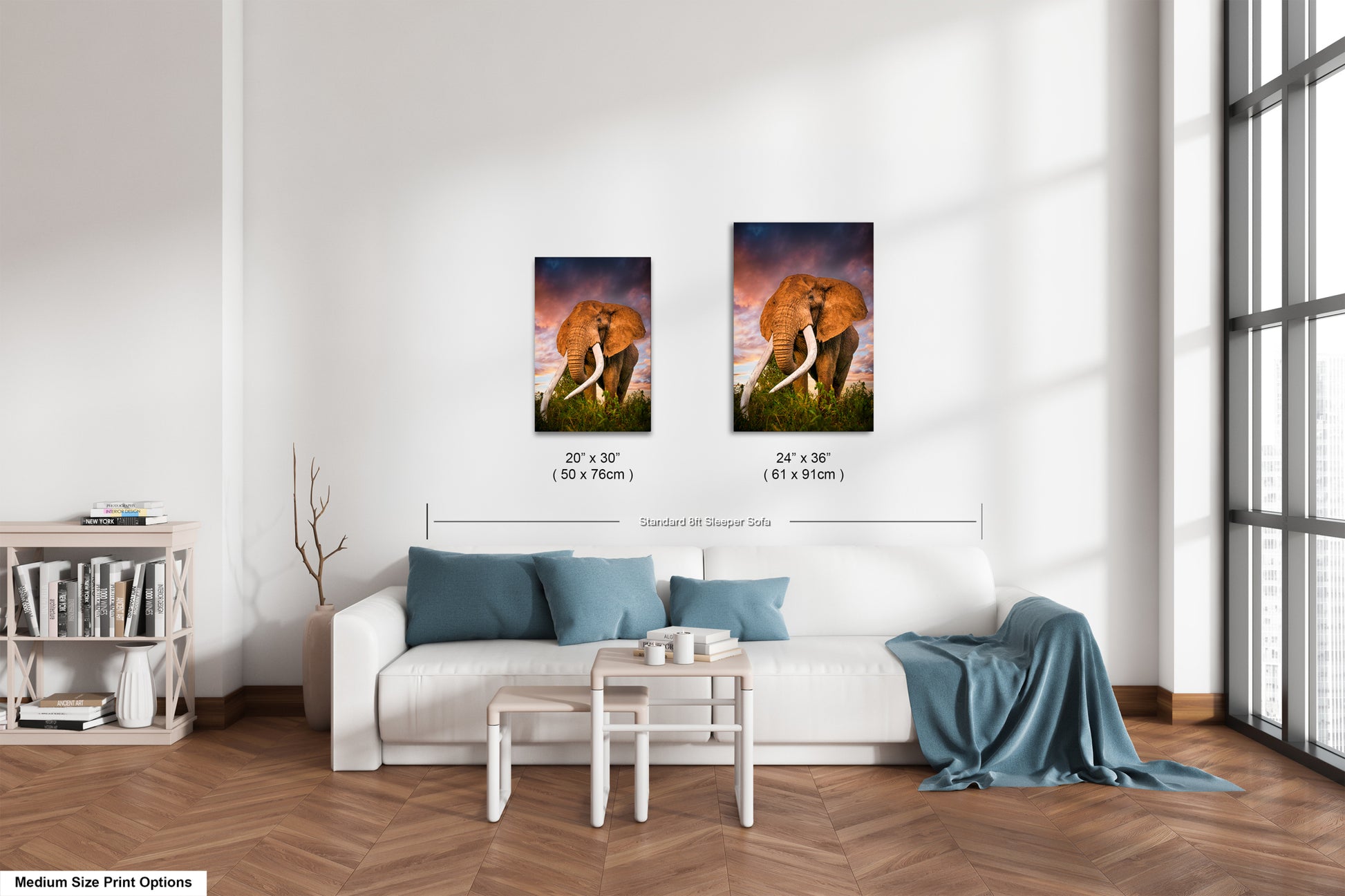 a living room with a white couch and two pictures on the wall