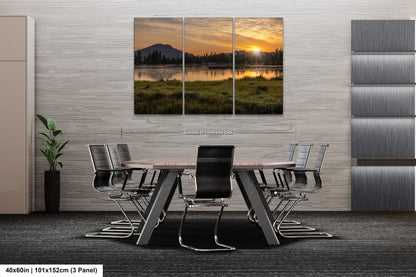a dining room table with chairs and a painting on the wall