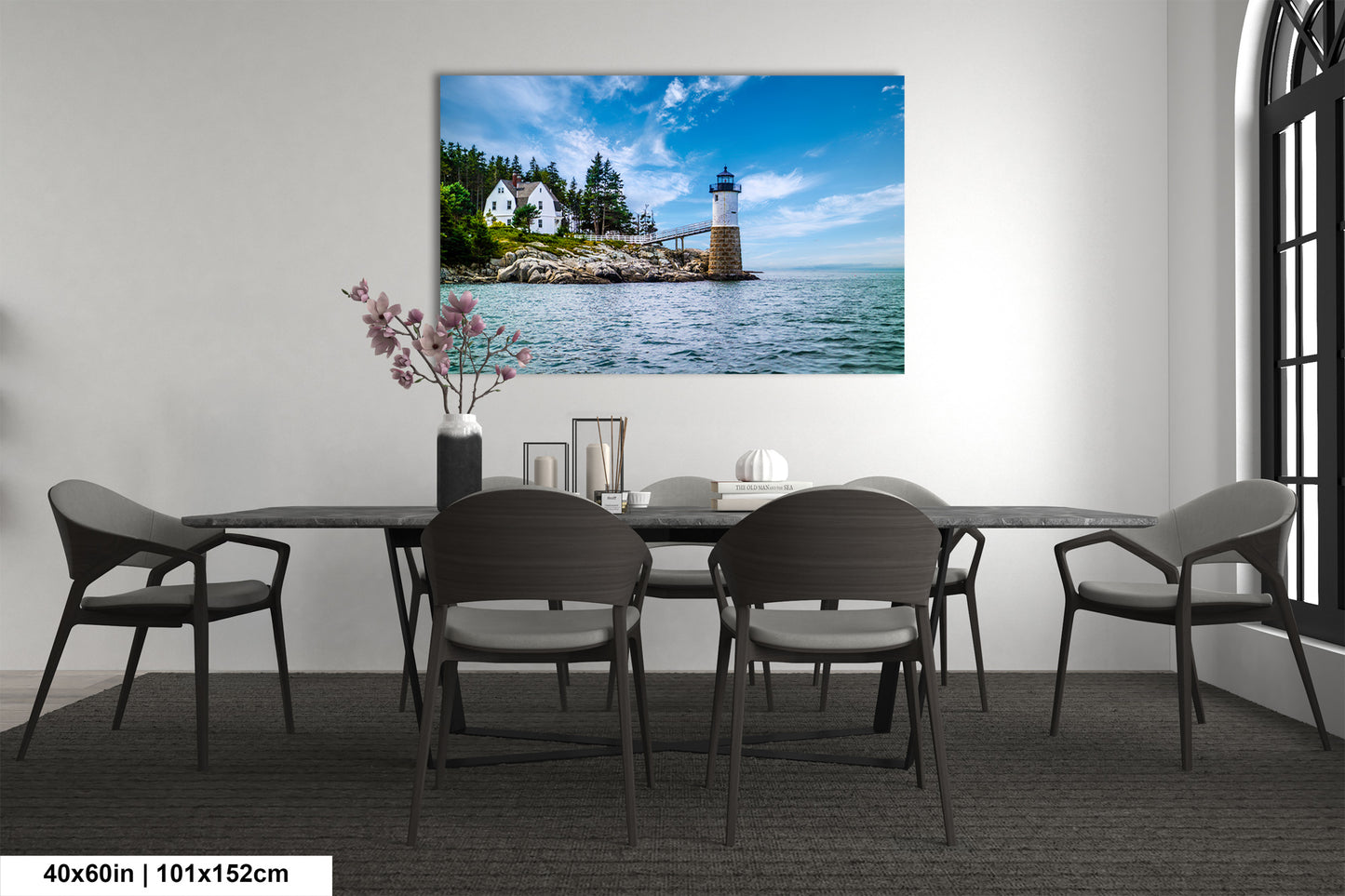 a room with a table and chairs and a picture of a lighthouse