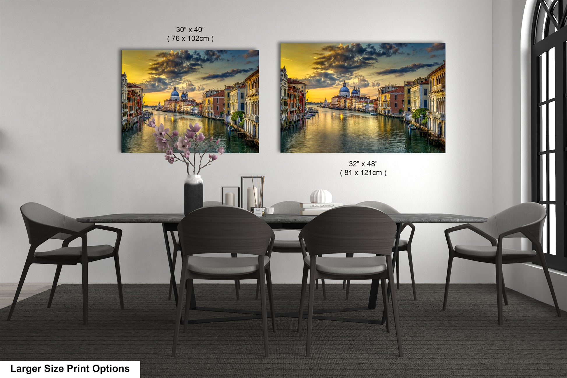 a dining room table with chairs and a painting on the wall