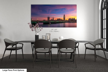 a dining room table with chairs and a painting on the wall